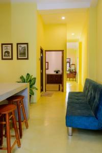 a living room with a blue couch and a table at Villa302 in Galle