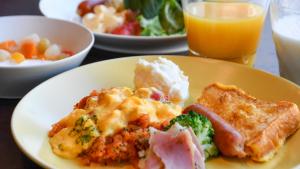 a plate of food on a table with food at Kotoni Green Hotel in Sapporo