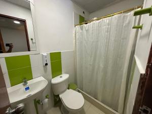 a bathroom with a toilet and a sink and a shower at Apartamentos FM 204 in Líbano