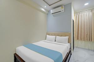 a small bedroom with a bed and a air conditioner at Hotel Broholi Height Inn Near Hafeezpet Railway Station in Hyderabad +16 photos