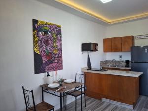 a kitchen with a table and a refrigerator at Noa Loft in Miravalle