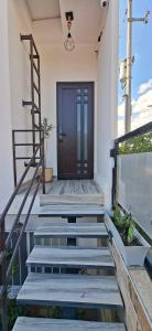 a front door of a house with stairs and a door at Noa Loft in Miravalle