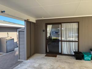 a house with a sliding glass door to a patio at Quiet & Close to Town in Taupo