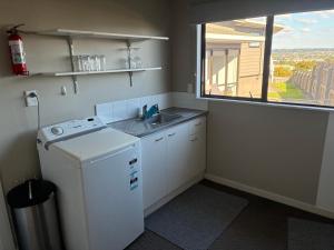 a small kitchen with a sink and a window at Quiet & Close to Town in Taupo +3 photos