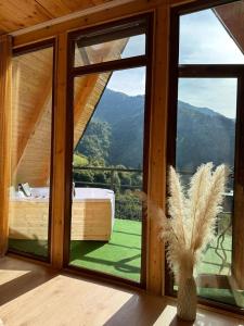 a room with a large window with a view of a mountain at warm house - sunrise merisi in Merisi