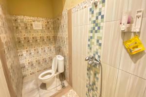 a bathroom with a toilet and a shower at Hotel O near Maguwoharjo Stadium formerly Graha Ngaso in Seturan +22 photos