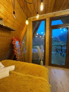 a bedroom with a bed and a large window at warm house - sunrise merisi in Merisi