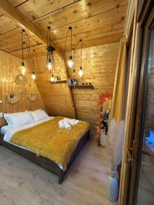 a bedroom with a bed in a room with wooden walls at warm house - sunrise merisi in Merisi