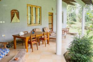 a dining room with a wooden table and chairs at Rivendell Twisted Tree in Kurunegala