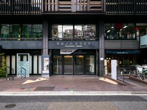 a building with the entrance to a store at Shijo Guesthouse HIVE in Kyoto