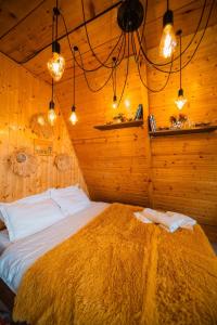 a bedroom with a bed in a wooden room at warm house - sunrise merisi in Merisi