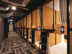 a row of empty lockers in a room at Shijo Guesthouse HIVE in Kyoto