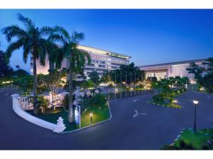 an overhead view of a city with palm trees and a building at Royal Ambarrukmo Yogyakarta in Yogyakarta