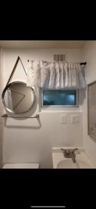 a bathroom with a mirror and a sink at Tiny house WiFi and parking in Miami