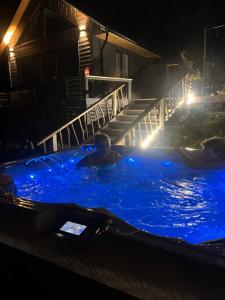 a group of people in a swimming pool at night at Evenes Artic glamping in Evenesmarkja