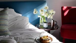 a plate of food on a table next to a bed at Yallungah Boutique Hotel in Orange +27 photos