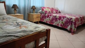 a bedroom with two beds and two lamps on night stands at Skyline View Garden Apartment in Bel Ombre