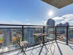 een balkon met twee stoelen en uitzicht op een stad bij Corporate Stays Hazel 1 Bedroom in Burnaby