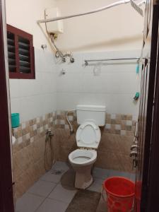 a bathroom with a toilet and a shower at Sohan Boarding and Lodging in Perdūru
