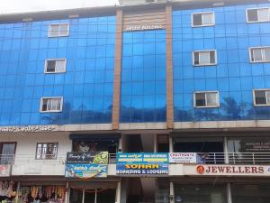 a blue building with signs on the side of it at Sohan Boarding and Lodging in Perdūru