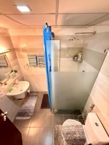 a bathroom with a tub and a toilet and a sink at Colombo City Escape 2BR Apartment - Nugegoda in Nugegoda
