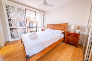 a bedroom with a large bed and a window at Seaside Apartments Broadbeach in Gold Coast