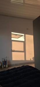 een slaapkamer met een raam en een bed erin bij DREAMS INN guest house in Maun