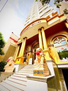 a yellow building with a staircase in front of it at Moonlight Hotel & Apartment in Da Nang +9 photos