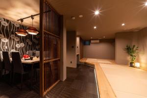 a dining room and living room with a table and chairs at おやど紀伊国屋宝町 in Nagasaki +95 photos