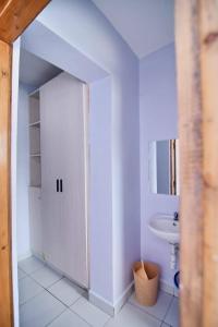 a white bathroom with a sink and a toilet at BUXTON New Furnished Apartments in Mombasa