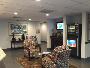 a waiting room with two chairs and a tv at Pleasant Hill Inn in Pleasant Hill