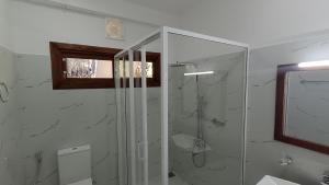 a bathroom with a shower and a glass shower stall at Ameliora Hotel Ella in Ella +38 photos