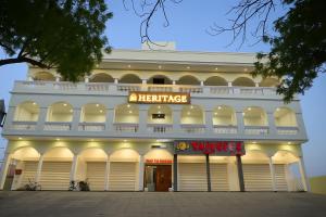 Un gran edificio blanco con un cartel en él. en Hotel Heritage Grand Bathinda # Parking # A Beautiful Property, en Bathinda