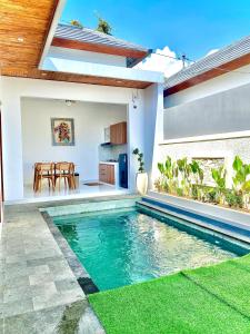 a swimming pool in the middle of a house at Villa Bulan by MentariPro Bali in Singaraja