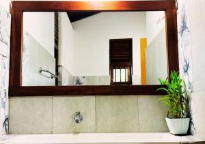 a mirror above a sink in a bathroom at Osara Holiday Home in Anuradhapura +59 photos