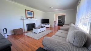 サセックス・インレットにあるThe Blue Lagoonのソファと暖炉のあるリビングルーム