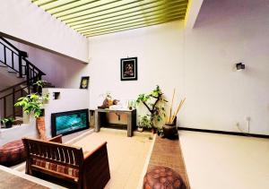 a living room with a couch and a fireplace at Osara Holiday Home in Anuradhapura