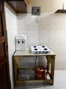 a small kitchen with a counter with a stove and aounter at Mombasa Town CBD Studio in Mombasa