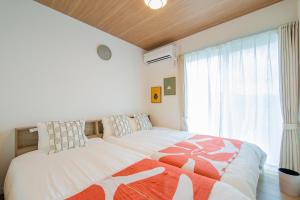 Ένα ή περισσότερα κρεβάτια σε δωμάτιο στο RENVI Ukiha ー福岡の宿ー