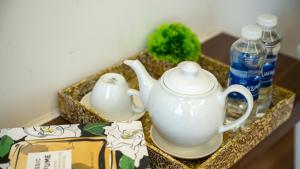 a tea kettle and water bottles on a table at Son Tra homestay in Danang