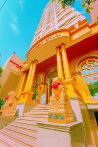 a yellow building with a staircase in front of it at Moonlight Hotel & Apartment in Da Nang