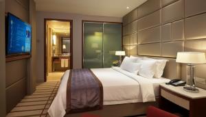 Ένα ή περισσότερα κρεβάτια σε δωμάτιο στο Indochine Hotel Hoi An