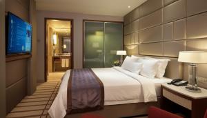 Ένα ή περισσότερα κρεβάτια σε δωμάτιο στο Indochine Hotel Hoi An