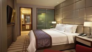 Ένα ή περισσότερα κρεβάτια σε δωμάτιο στο Indochine Hotel Hoi An