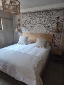 a bedroom with a large white bed and a wall at Luvlé Lux Apartments in Eros Airport