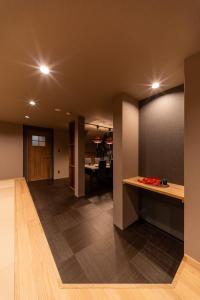 an empty room with a kitchen and a dining room at おやど紀伊国屋宝町 in Nagasaki