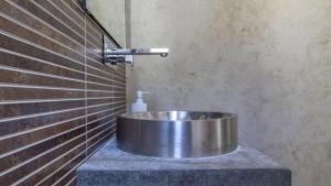 a bathroom with a metal sink in the corner at Villa de Luxe in San José +14 photos