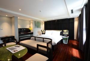 a hotel room with a bed and a table at The Chi Boutique Hotel in Hanoi
