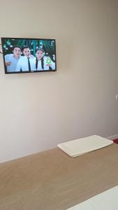 a flat screen tv hanging on a white wall at КзО in Shymkent +17 photos