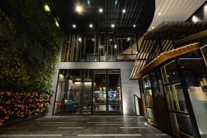 an entrance to a building with glass doors and plants at The Chi Boutique Hotel in Hanoi